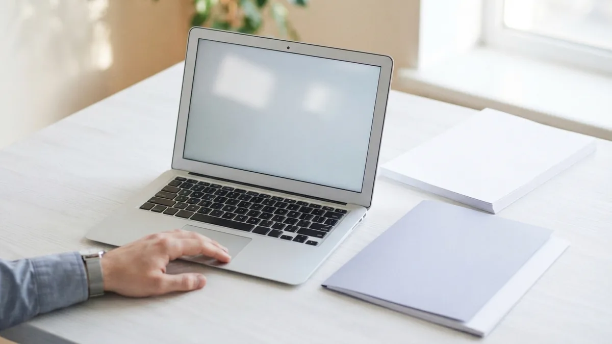 Laptop with blank papers and folder arranged for a step-by-step PDF editing task