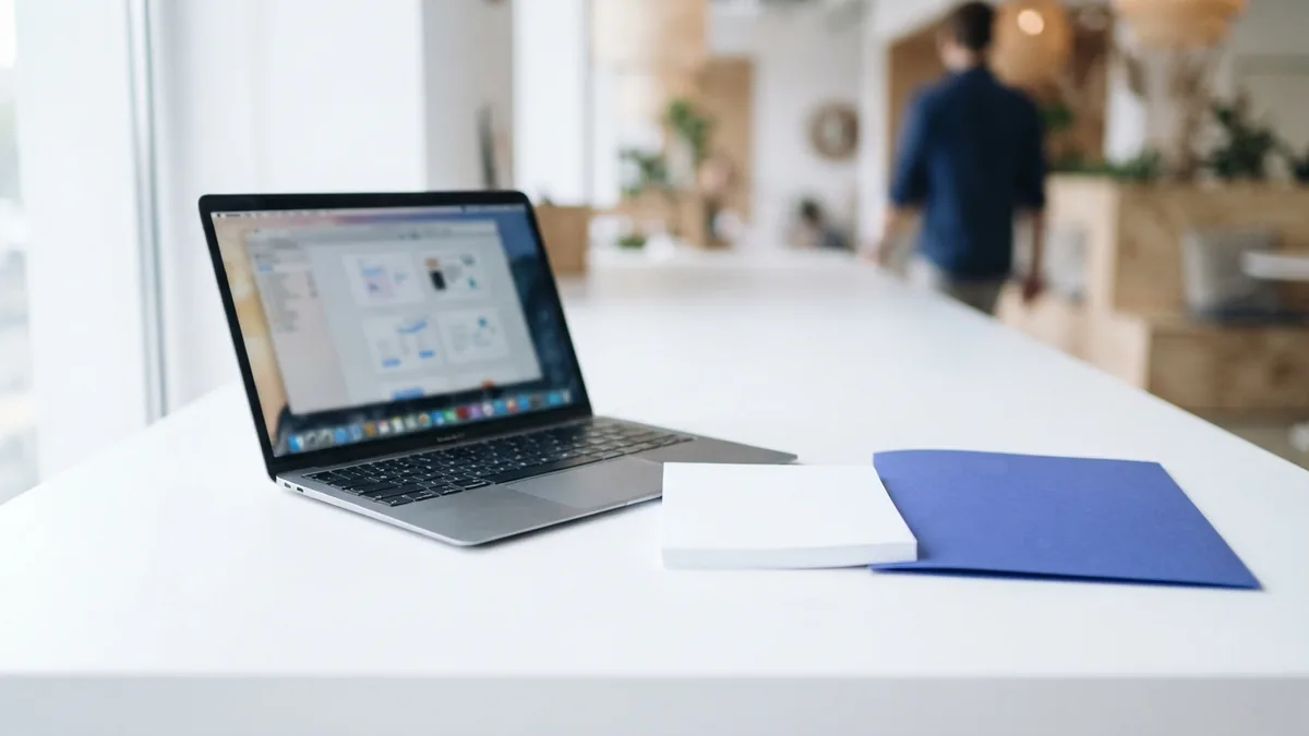 A simple desk setup for PDF work Laptop and blank paper on an airy desk prepared for PDF file work