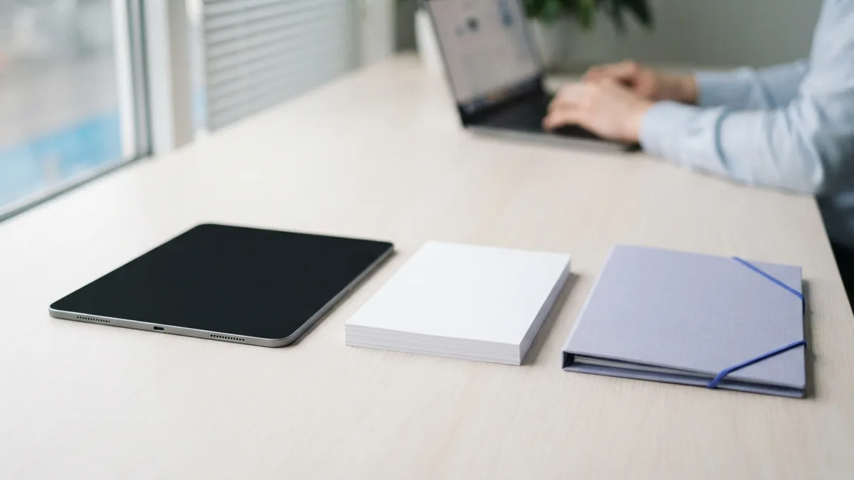 Tablet and blank documents arranged for turning scanned pages into searchable PDFs