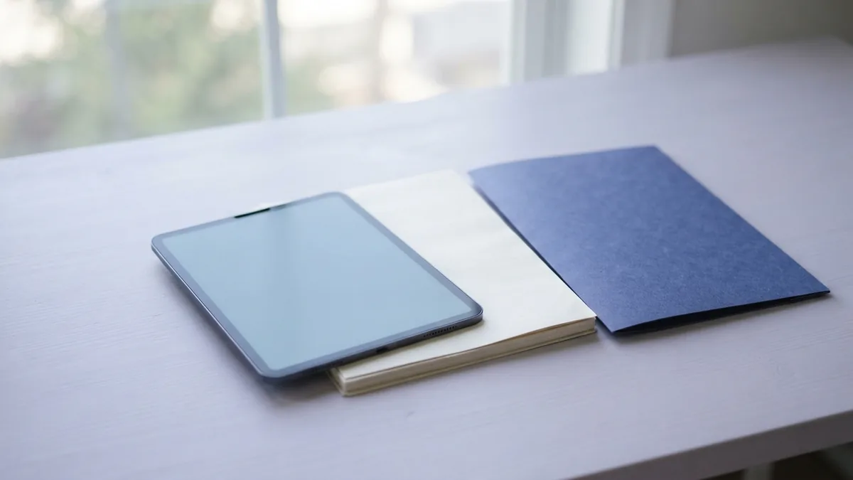 Export documents as PDF files Tablet with blank pages and a blue folder ready for PDF export