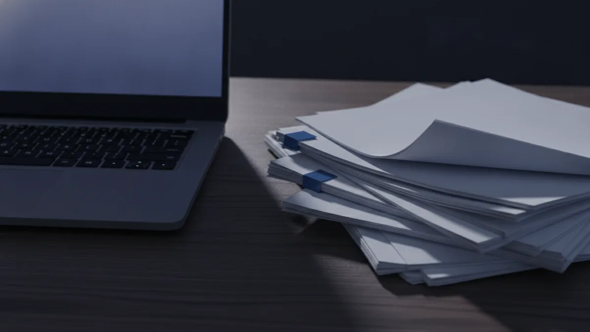What “default” means Laptop and documents on a desk to illustrate choosing a PDF app.
