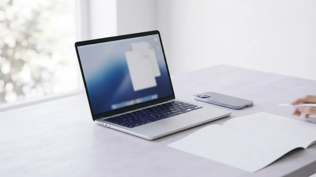 Convert files across your devices Smartphone and laptop beside blank papers for converting files to PDF