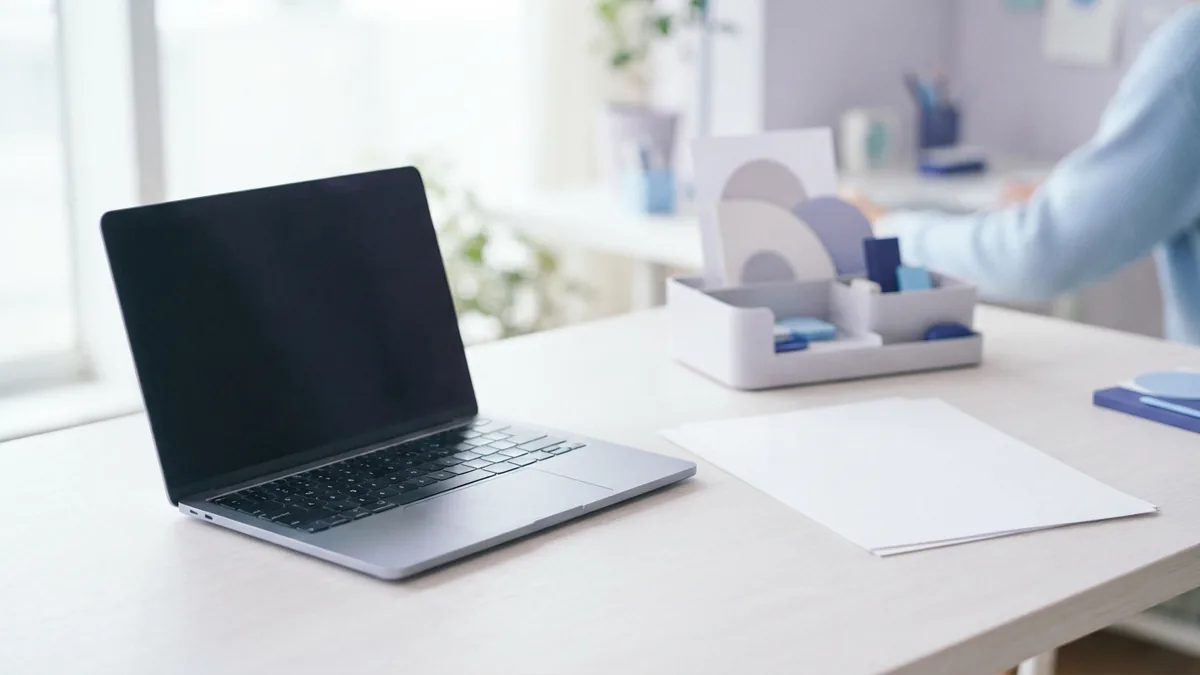 Laptop and blank papers beside local storage for desktop PDF work